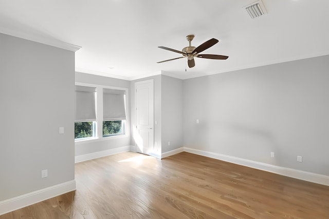 unfurnished room with crown molding, ceiling fan, and light wood-type flooring