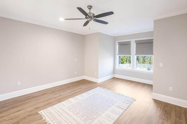 empty room with light hardwood / wood-style flooring, ceiling fan, and crown molding