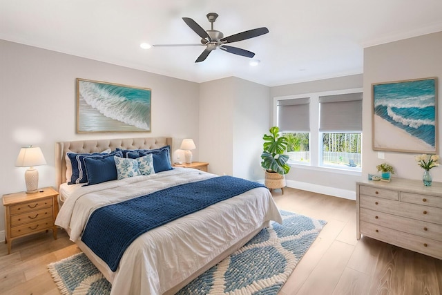 bedroom featuring ceiling fan, crown molding, and light hardwood / wood-style floors