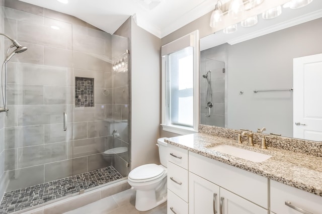 bathroom with tile patterned floors, toilet, a shower with door, vanity, and ornamental molding