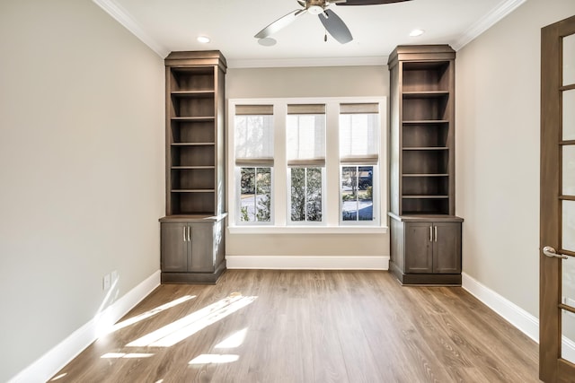 unfurnished living room with ceiling fan, light wood-type flooring, and ornamental molding