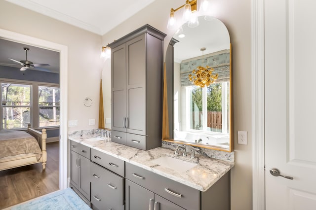 bathroom with vanity, a wealth of natural light, ceiling fan, and hardwood / wood-style flooring