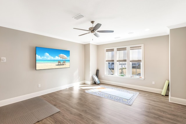 interior space featuring ceiling fan, crown molding, and wood-type flooring