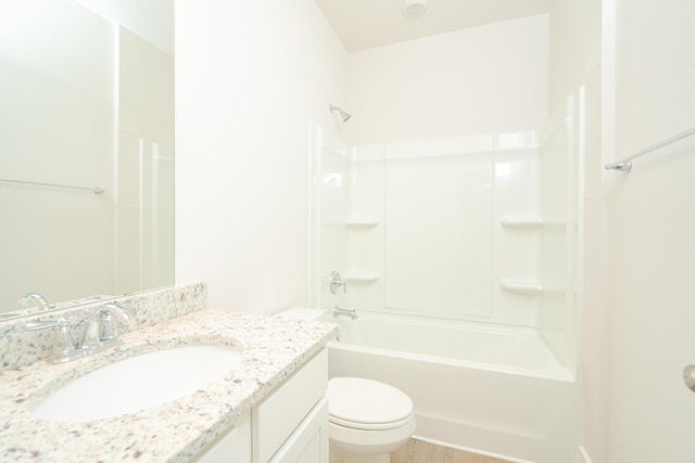 full bathroom featuring vanity, hardwood / wood-style flooring, toilet, and shower / washtub combination