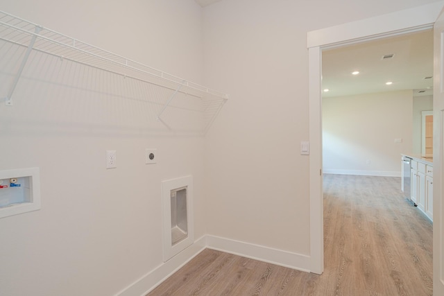 clothes washing area with washer hookup, electric dryer hookup, and light hardwood / wood-style flooring