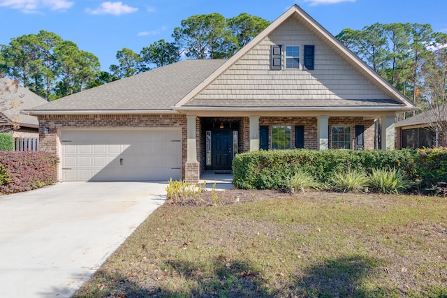 view of front of property with a front yard and a garage