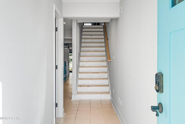 staircase with tile patterned floors