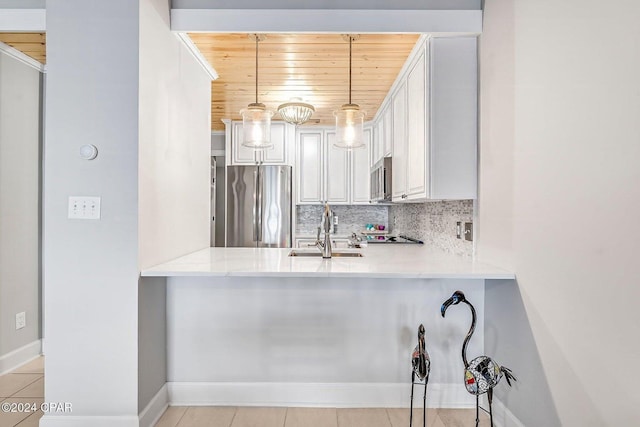 kitchen with wooden ceiling, sink, hanging light fixtures, decorative backsplash, and stainless steel appliances