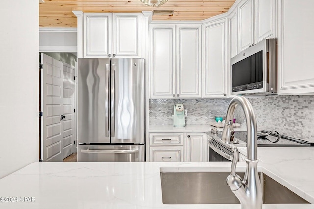 kitchen with wood ceiling, light stone countertops, white cabinets, and stainless steel appliances