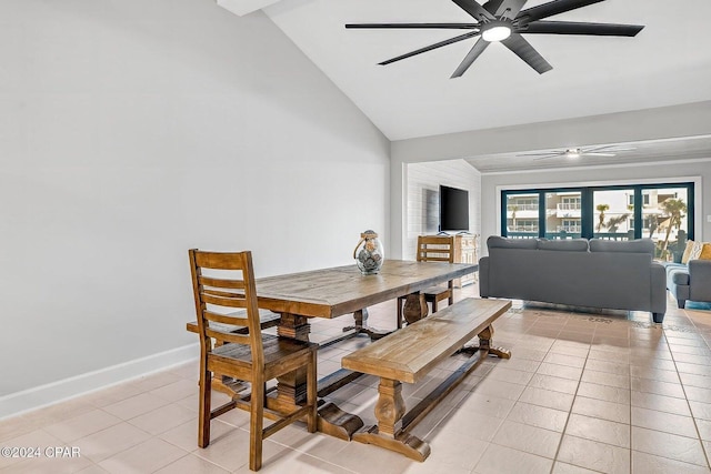 tiled dining room featuring ceiling fan and lofted ceiling