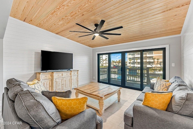 tiled living room featuring lofted ceiling, wooden walls, ceiling fan, and wooden ceiling