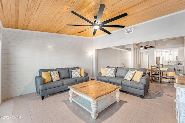 living room with wooden walls, light tile patterned floors, wood ceiling, and lofted ceiling