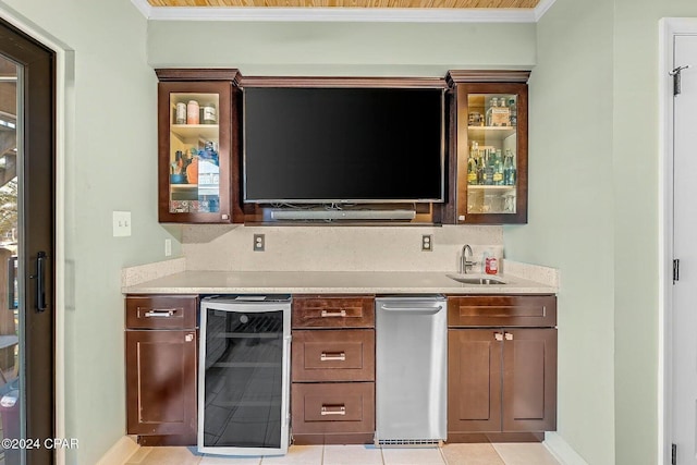 bar featuring wine cooler, crown molding, sink, and light tile patterned floors