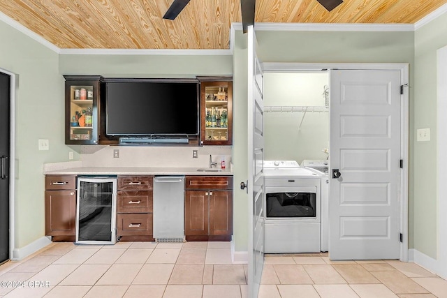 kitchen featuring ornamental molding, washing machine and dryer, wine cooler, and wooden ceiling