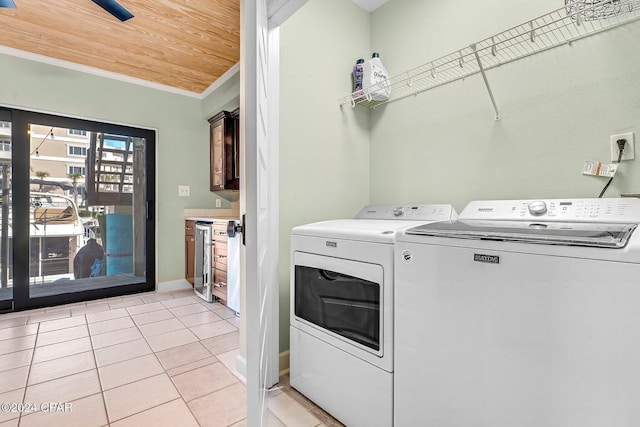 washroom with ornamental molding, beverage cooler, light tile patterned floors, wooden ceiling, and washing machine and dryer