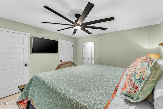 tiled bedroom featuring ceiling fan