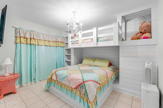 bedroom featuring tile patterned floors and a notable chandelier