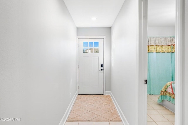 entryway with light tile patterned flooring