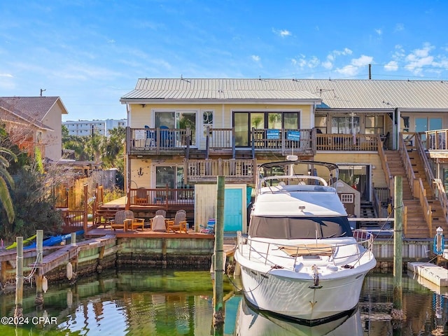 rear view of house featuring a water view