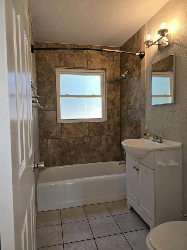 full bathroom featuring tile patterned floors, tiled shower / bath combo, a textured ceiling, and vanity