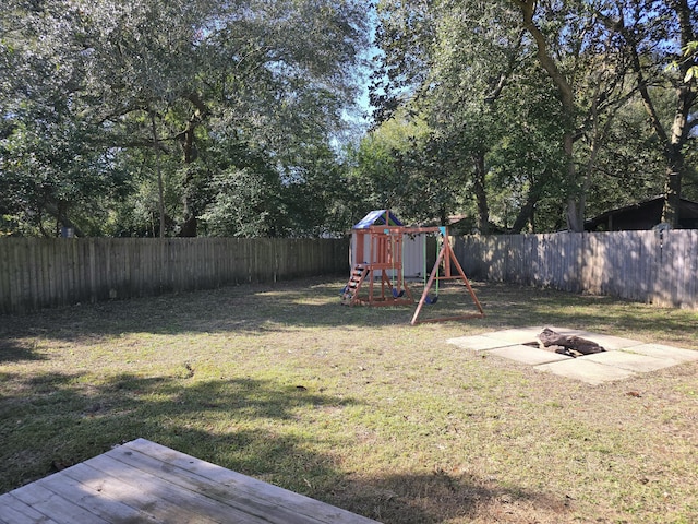 view of yard with a playground and a fire pit