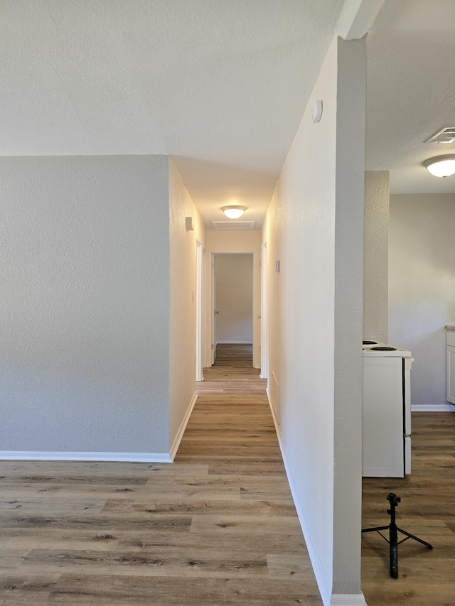 corridor with light hardwood / wood-style flooring