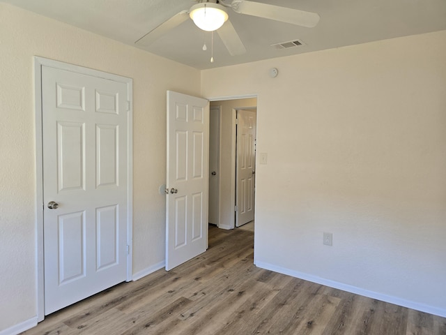 unfurnished bedroom featuring ceiling fan and light hardwood / wood-style floors