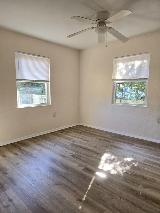 spare room featuring ceiling fan and dark hardwood / wood-style flooring