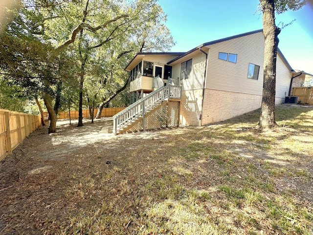 rear view of house featuring central AC