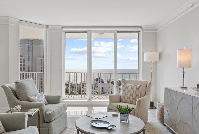 living room featuring a water view, ornamental molding, and floor to ceiling windows