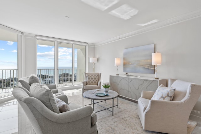 living room featuring ornamental molding, a water view, and a wall of windows