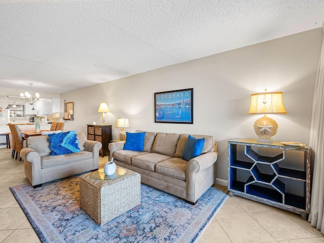 living room with a chandelier, a textured ceiling, and light tile patterned flooring