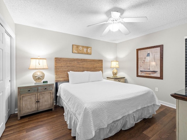 bedroom featuring dark hardwood / wood-style flooring, a textured ceiling, a closet, and ceiling fan