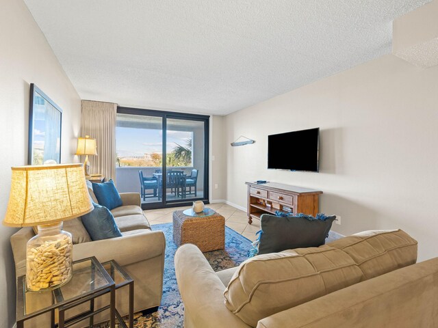 tiled living room featuring a textured ceiling and expansive windows