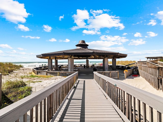 dock area featuring a beach view, a gazebo, and a water view