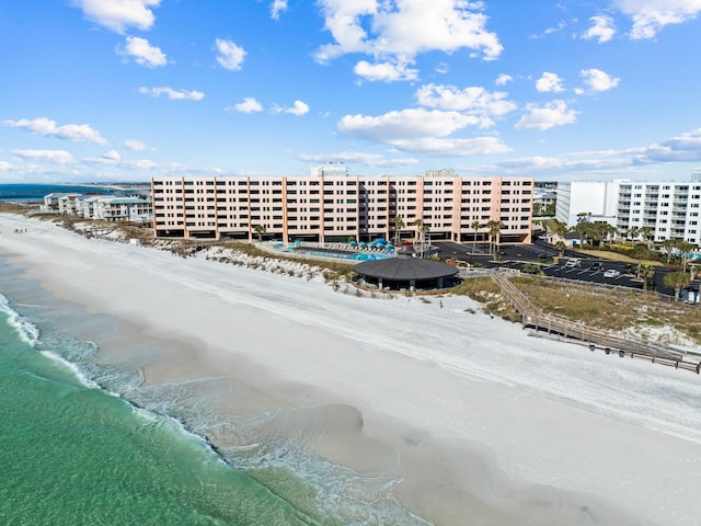 drone / aerial view featuring a water view and a view of the beach