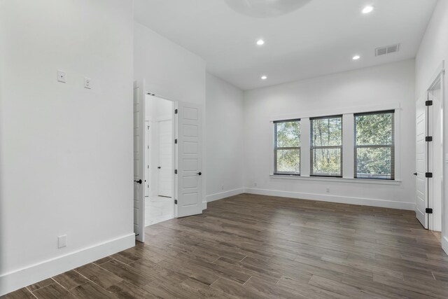 unfurnished room with dark hardwood / wood-style floors