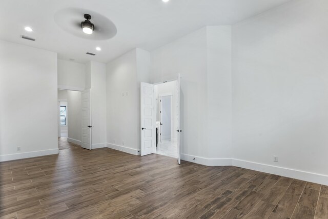 empty room featuring ceiling fan and dark hardwood / wood-style flooring