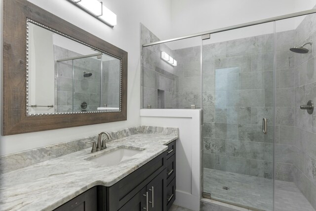 bathroom with vanity and a shower with shower door