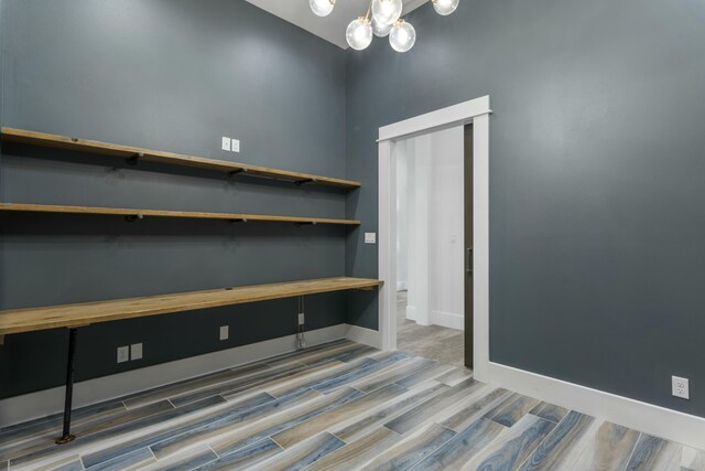 interior space featuring hardwood / wood-style floors and a notable chandelier