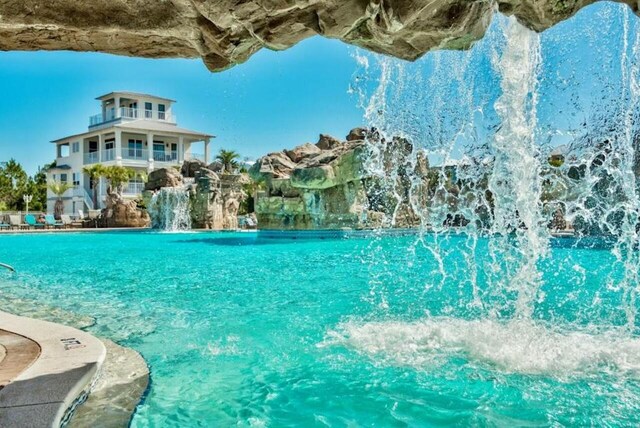 view of swimming pool featuring pool water feature