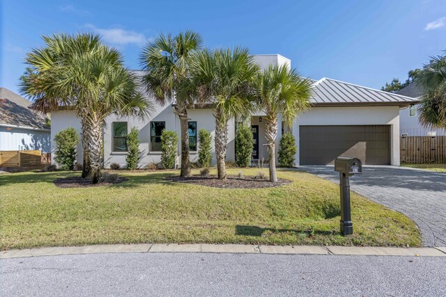 view of front of property featuring a garage and a front yard