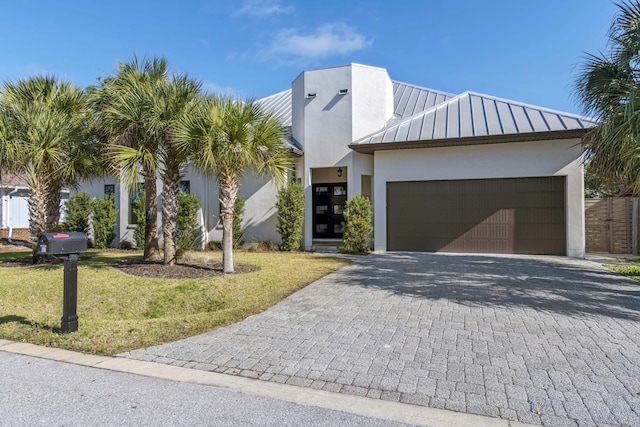 view of front of house featuring a front lawn and a garage