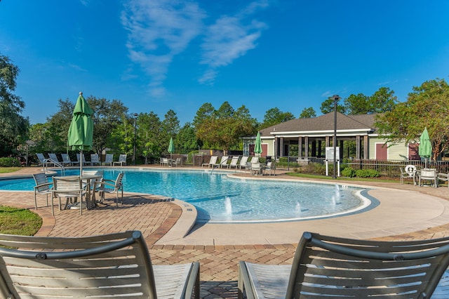 view of pool featuring pool water feature and a patio area