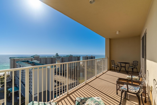 balcony with a water view and a beach view