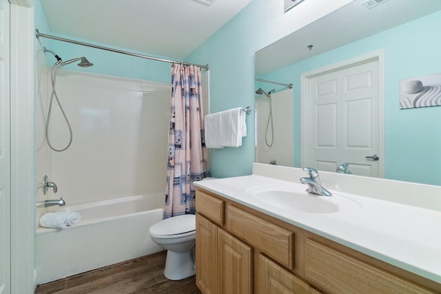 full bathroom featuring vanity, wood-type flooring, shower / tub combo, and toilet