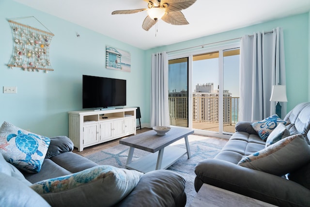 living room featuring ceiling fan and light hardwood / wood-style flooring