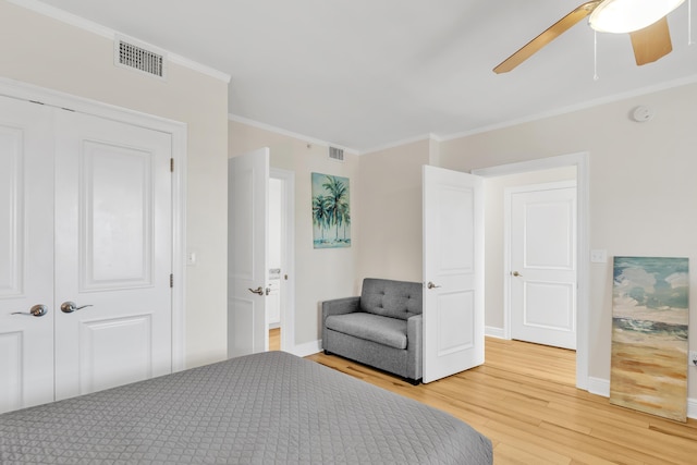 unfurnished bedroom featuring a closet, ceiling fan, hardwood / wood-style floors, and ornamental molding