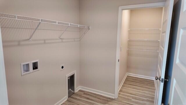 washroom with electric dryer hookup, wood-type flooring, and hookup for a washing machine