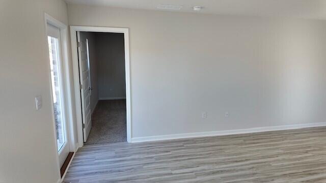 unfurnished room featuring light hardwood / wood-style floors